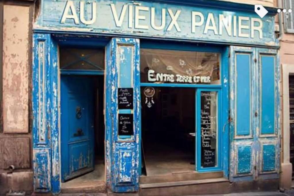 a blue building with a sign on the front of it at Studio 11 Panier Vieux Port Roof Top in Marseille