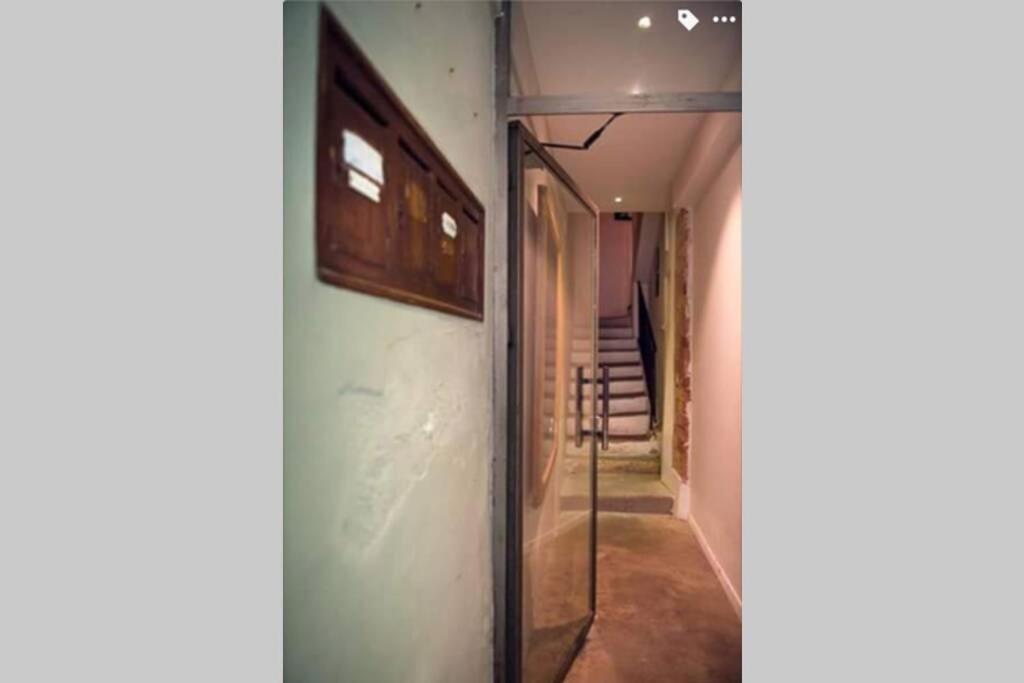 a hallway with a glass door and a stair case at Studio 11 Panier Vieux Port Roof Top in Marseille