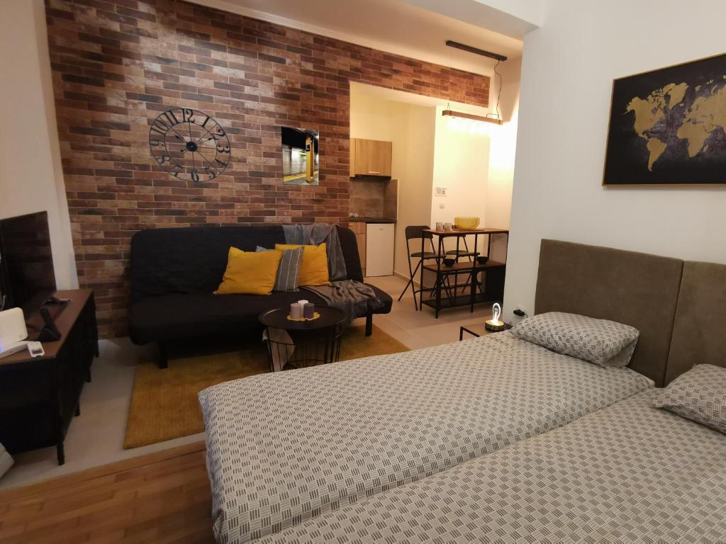 a living room with a bed and a couch at Cozy Studio next to Acropolis & Plaka in Athens