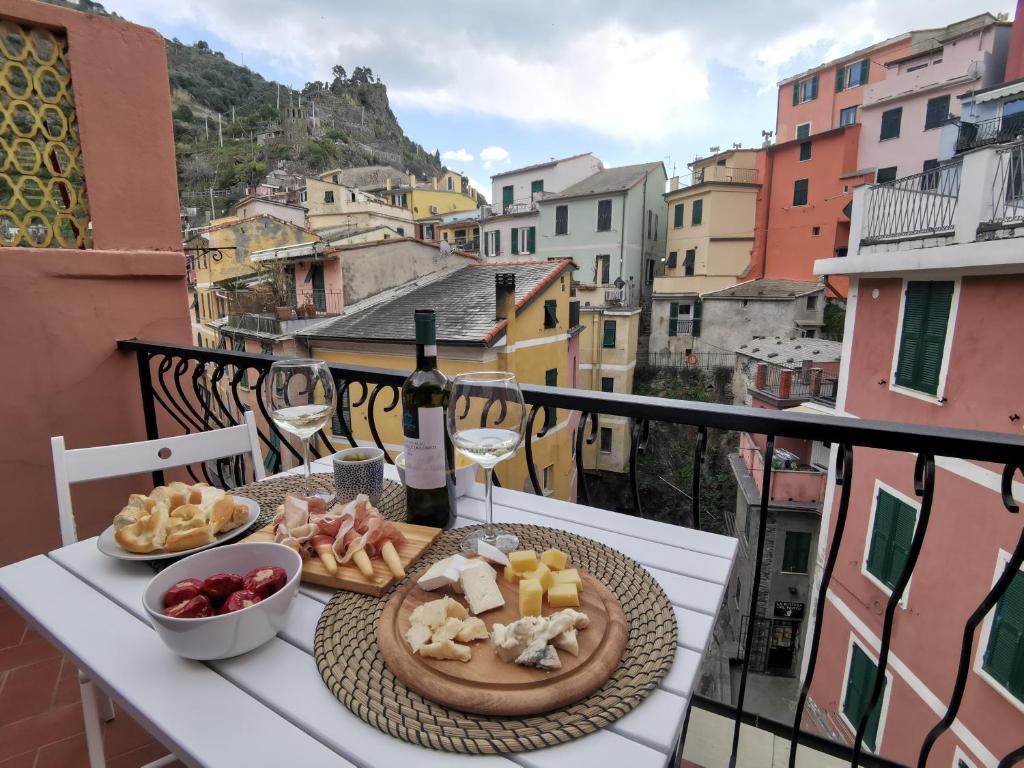 a plate of food on a table on a balcony at SeaBreeze Vernazza in Vernazza