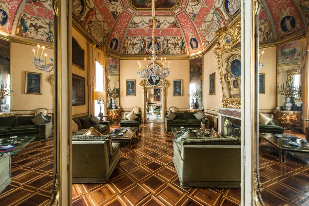 a living room with a ceiling and a room with couches at Residenza Ruspoli Bonaparte in Rome