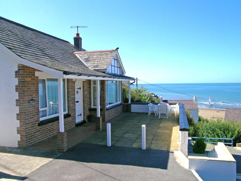 a house with a porch with a view of the ocean at Delyn Aur in Cardigan