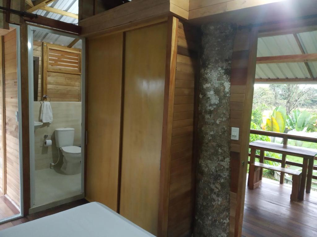 a bathroom with a toilet in a house at Hostal Suna Vito in Puerto Asís