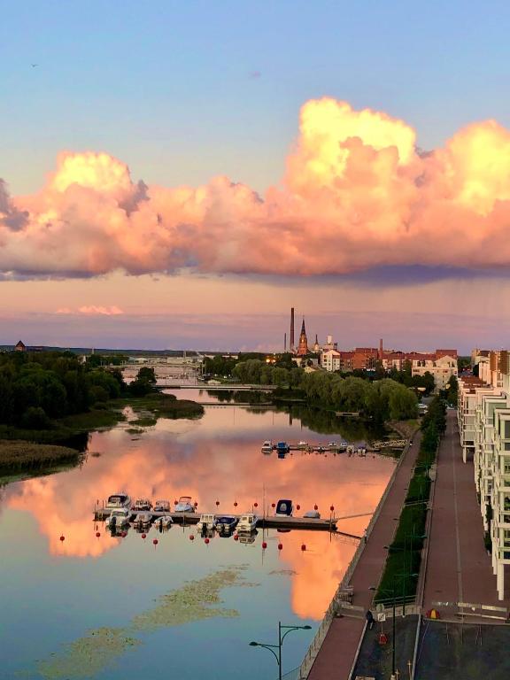a view of a river with boats in it at The River 31, Baritoni in Pori