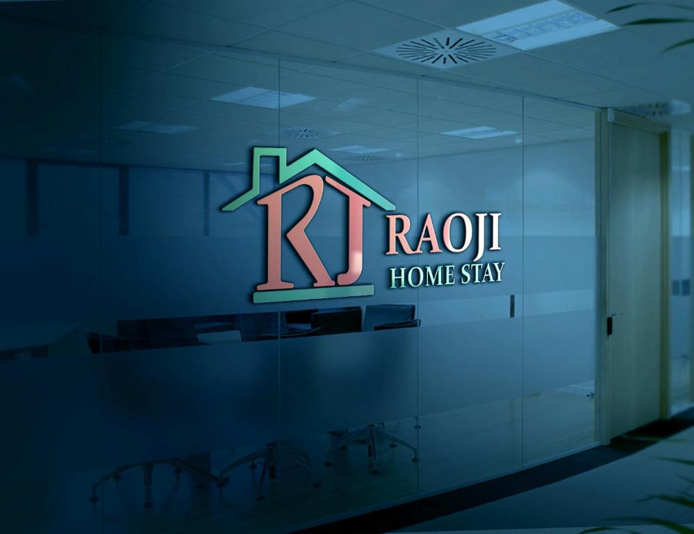 a logo for a home stay in a building at RAOJI Home Stay in Vālpārai