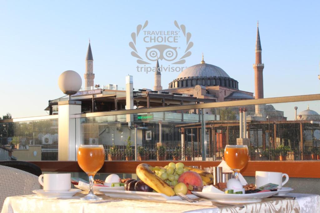 a table with a plate of food on it with a mosque at Nayla Palace Hotel-Special Category in Istanbul