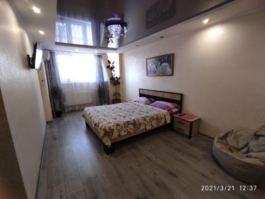 a bedroom with a bed and a window at Апартаменты новострой улица Замостянская 34 А in Vinnytsya