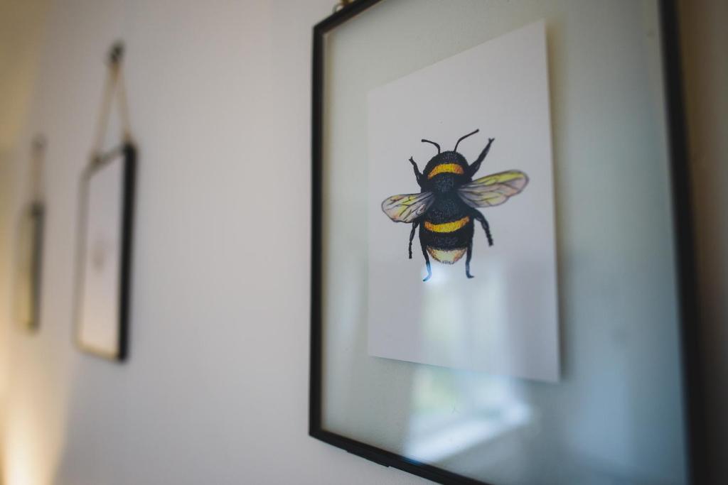 a picture of a bee in a mirror at Hectors house in Ormesby Saint Michael