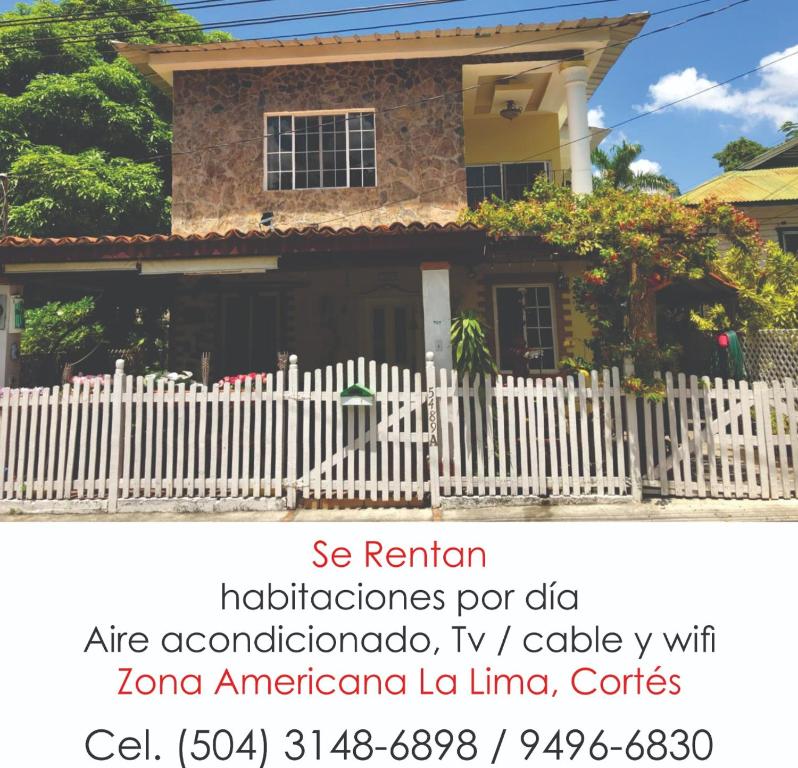 a picture of a house with a white fence at CASA DE HUESPEDES CASA BONITA in La Lima