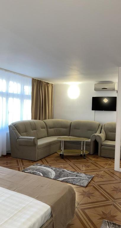 a living room with a couch and a table at Dany Holiday in Eforie Nord