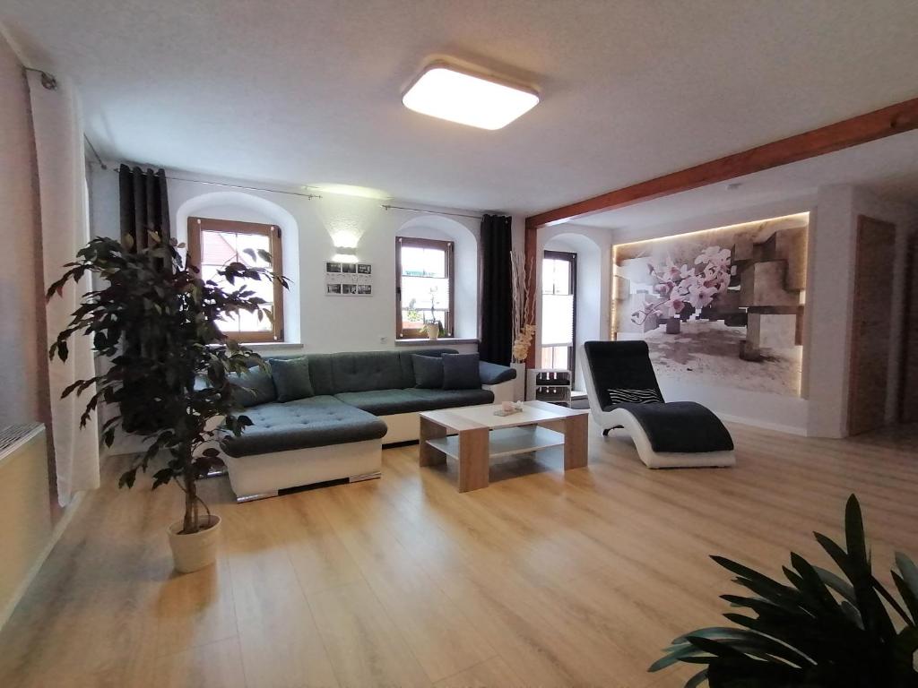 a living room with a couch and a table at Ferienwohnung Jurk in Bärenstein