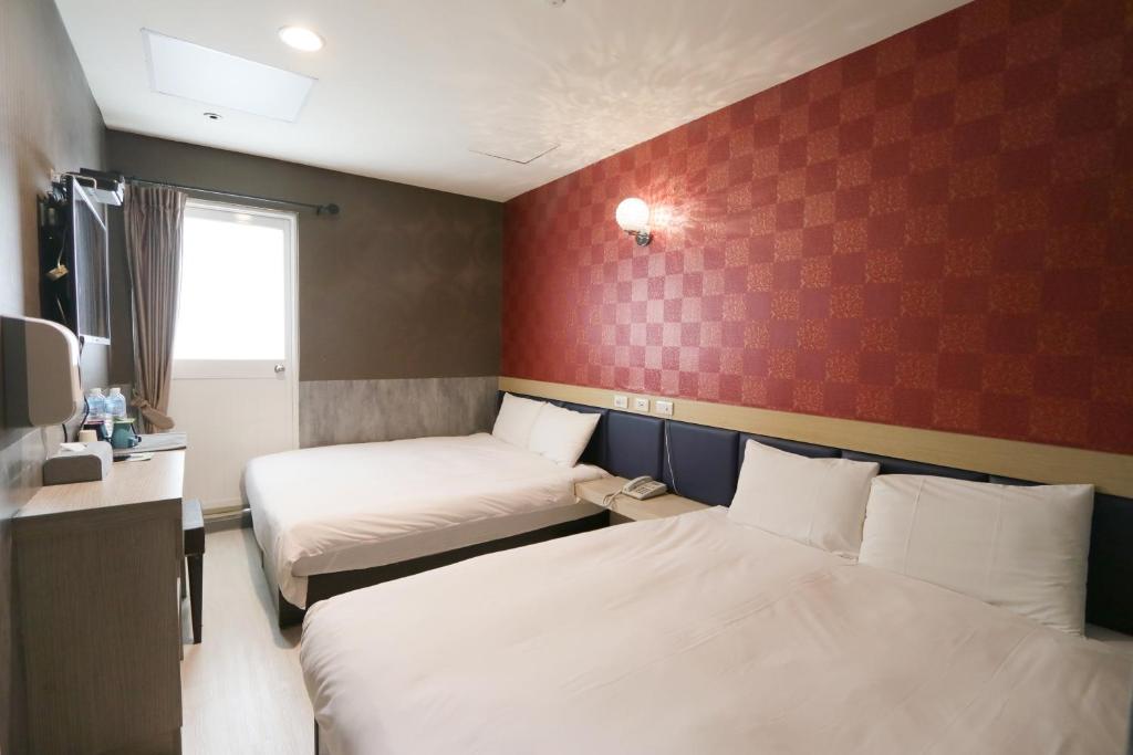 Postel nebo postele na pokoji v ubytování Chao She Hotel