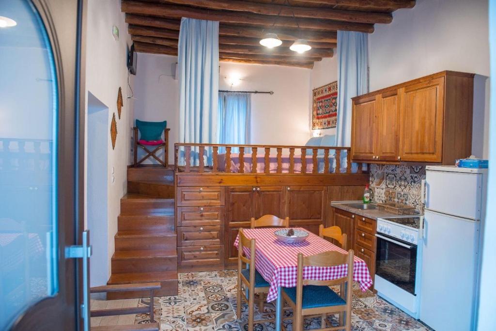 una cucina con tavolo, tavolo e sedie di Grandmother's house a Psinthos