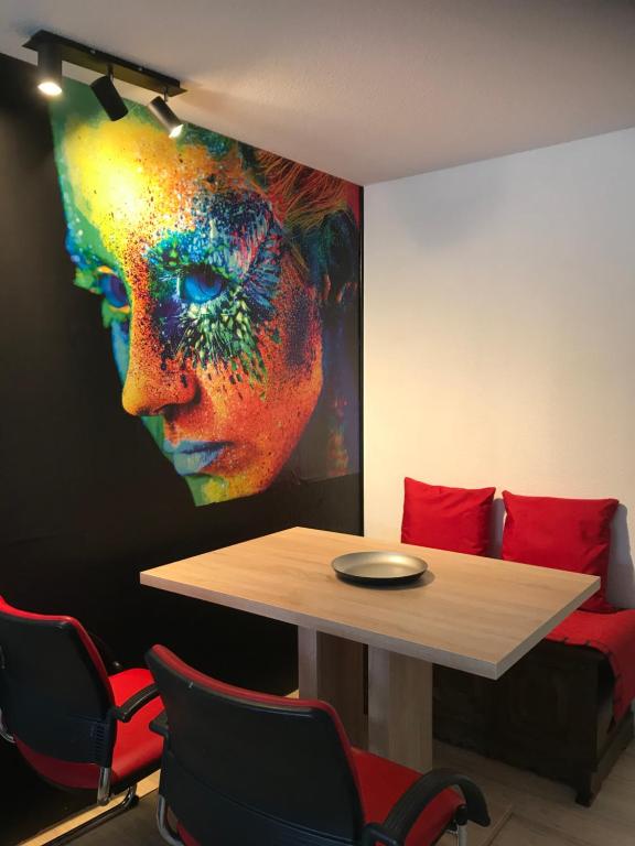 a table in a room with a painting of a woman at Haus Friedel 2 in Überlingen