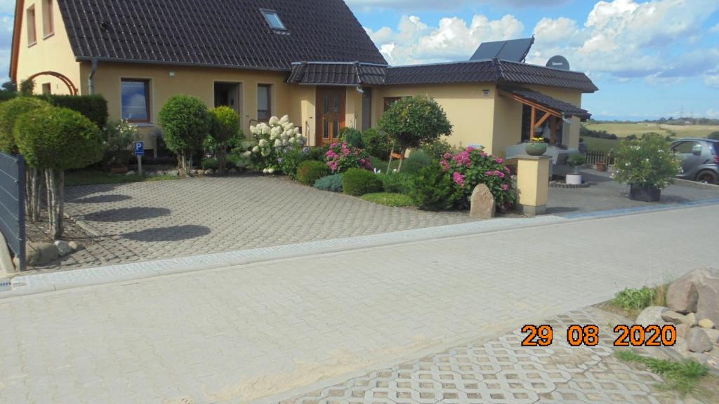 a house with a brick driveway in front of it at Ferienwohnung Beselin in Beselin