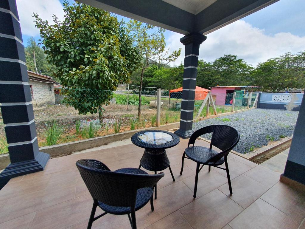 a patio with chairs and a table and a playground at Bauk View Homestay in Batu Lima
