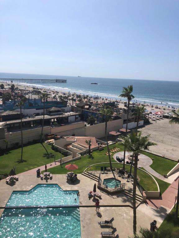 a view of the beach from the balcony of a resort at Breathtaking Oceana Del Mar in Rosarito