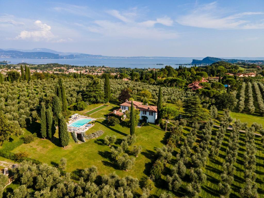 an aerial view of a estate with a house and trees at PODERI LA ROCCHETTA Countryside Estate on the Hills of Lake Garda in San Felice del Benaco