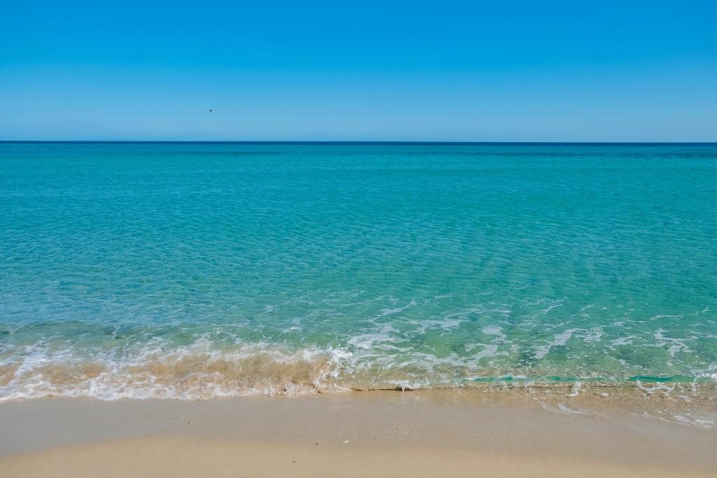 a view of the ocean from the beach at Sas Tilibbas-Ammentos Posada in Posada