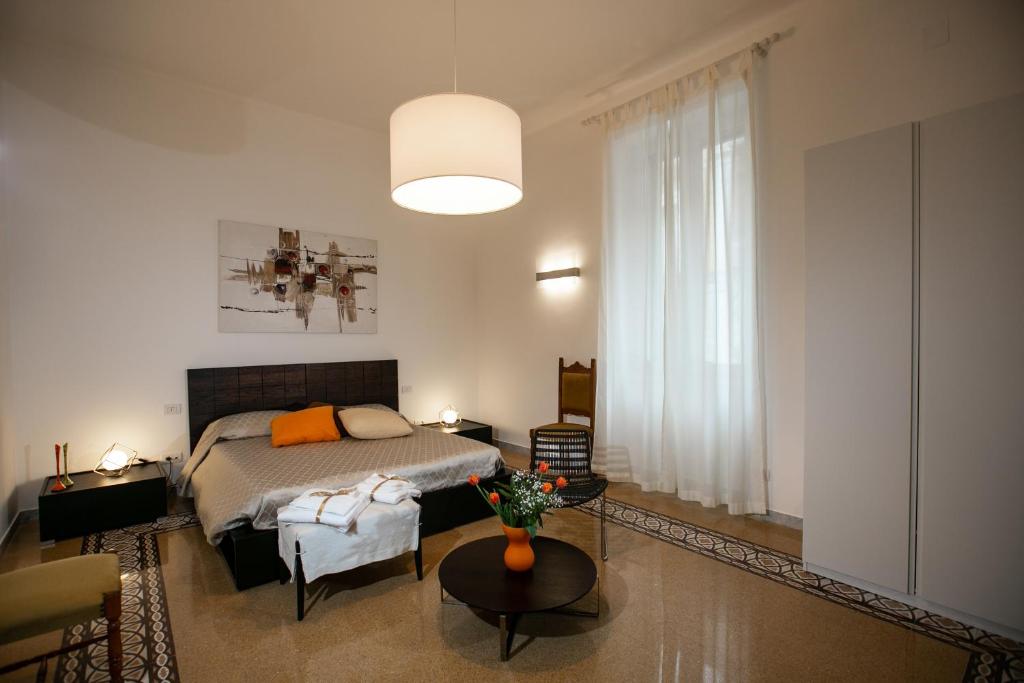 a bedroom with a bed and a couch and a table at Abate Luxury Interno 3 in Bari