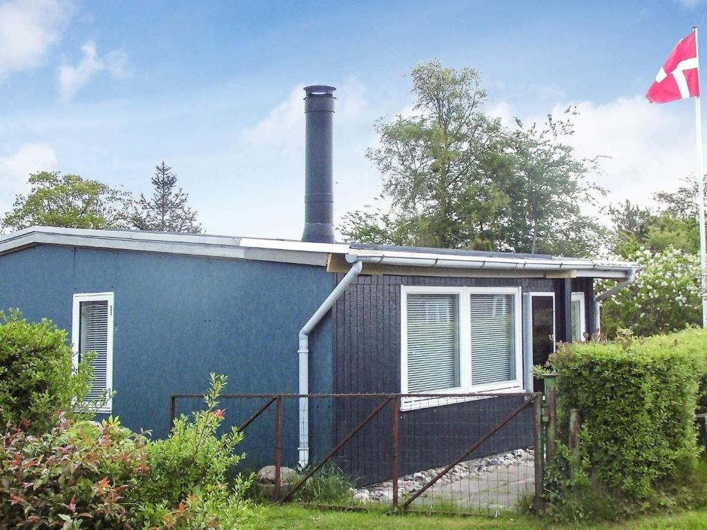 una casa azul con una chimenea encima en 4 person holiday home in Broager, en Broager