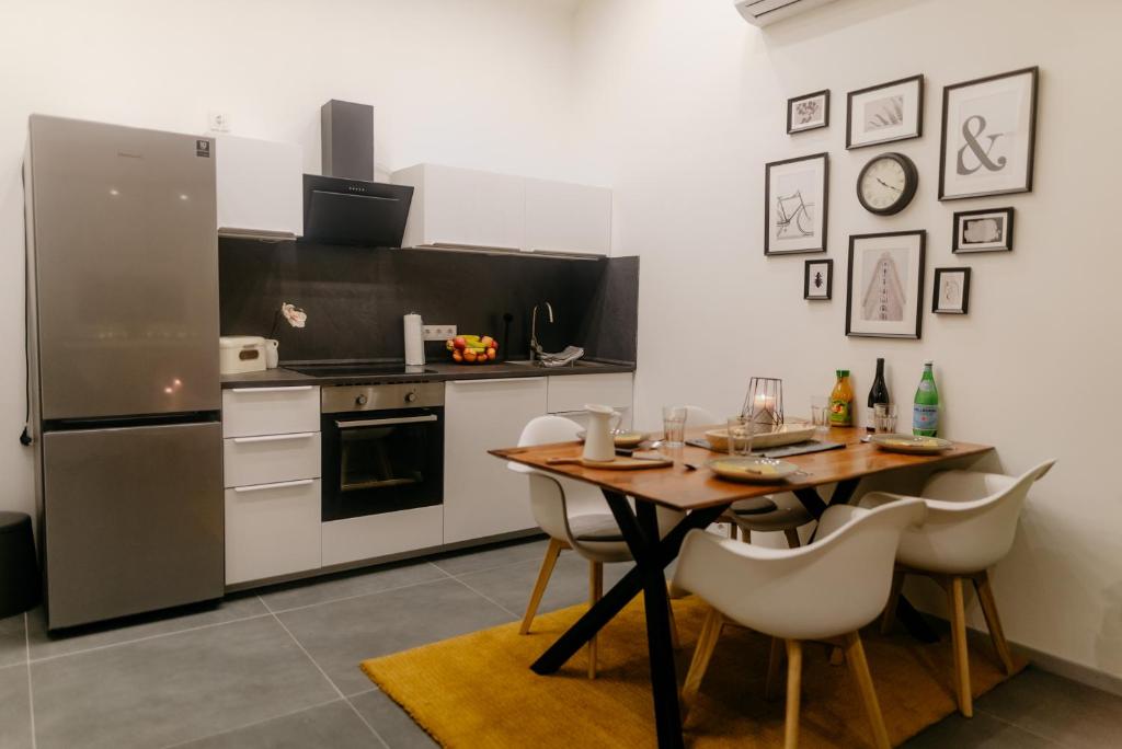 a kitchen with a wooden table and a refrigerator at Monteurzimmer Apartment for Workers Saarbrücken,Luxemburg,Überherrn, Pavan M2-KEINE Ferienwohnung in Saarlouis