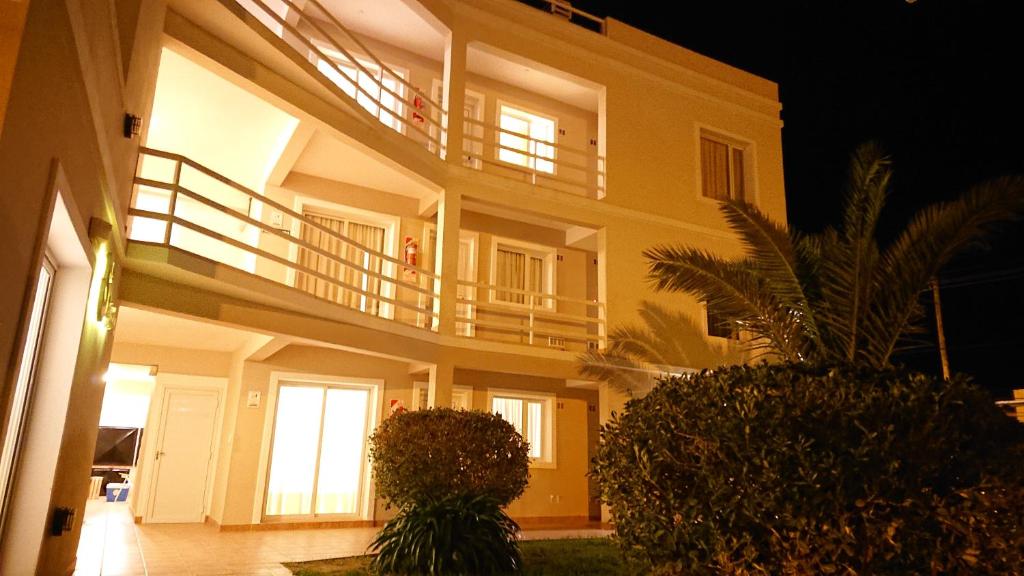 a large apartment building with a balcony at night at 5ta Bajada Las Grutas in Las Grutas