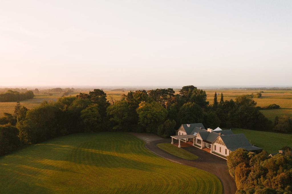 an aerial view of a house on a green field at Hiwinui Country Estate in Palmerston North