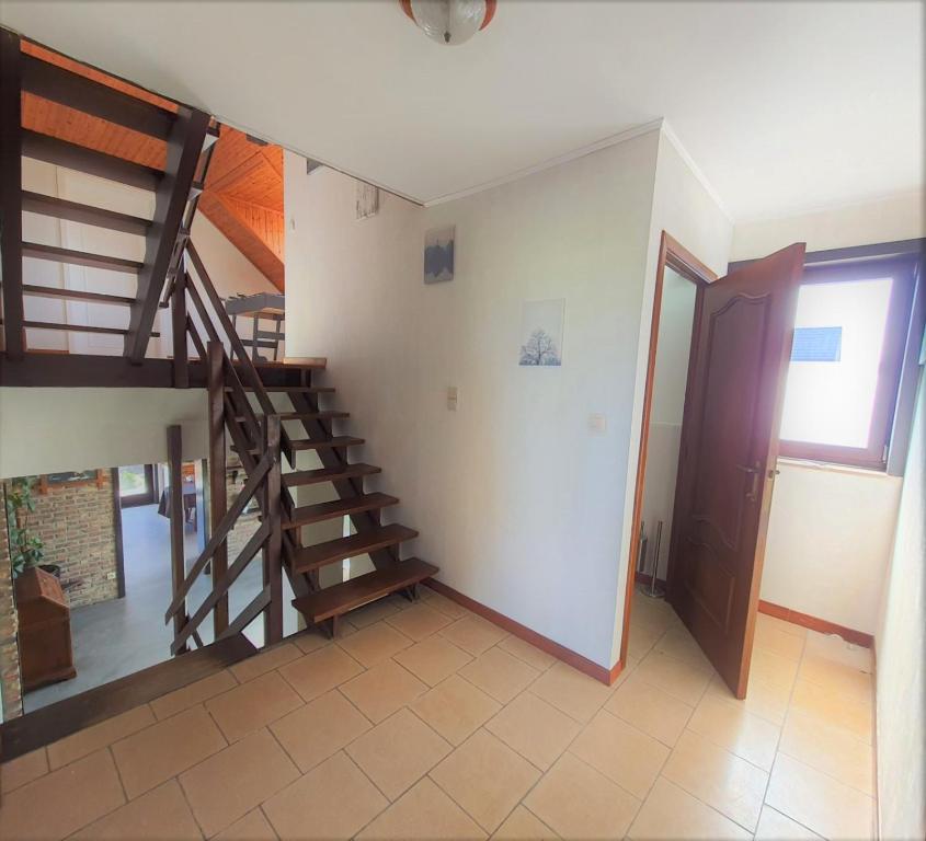 a living room with a staircase and a door at Maison de vacances située entre Liège, Tongres et Visé 