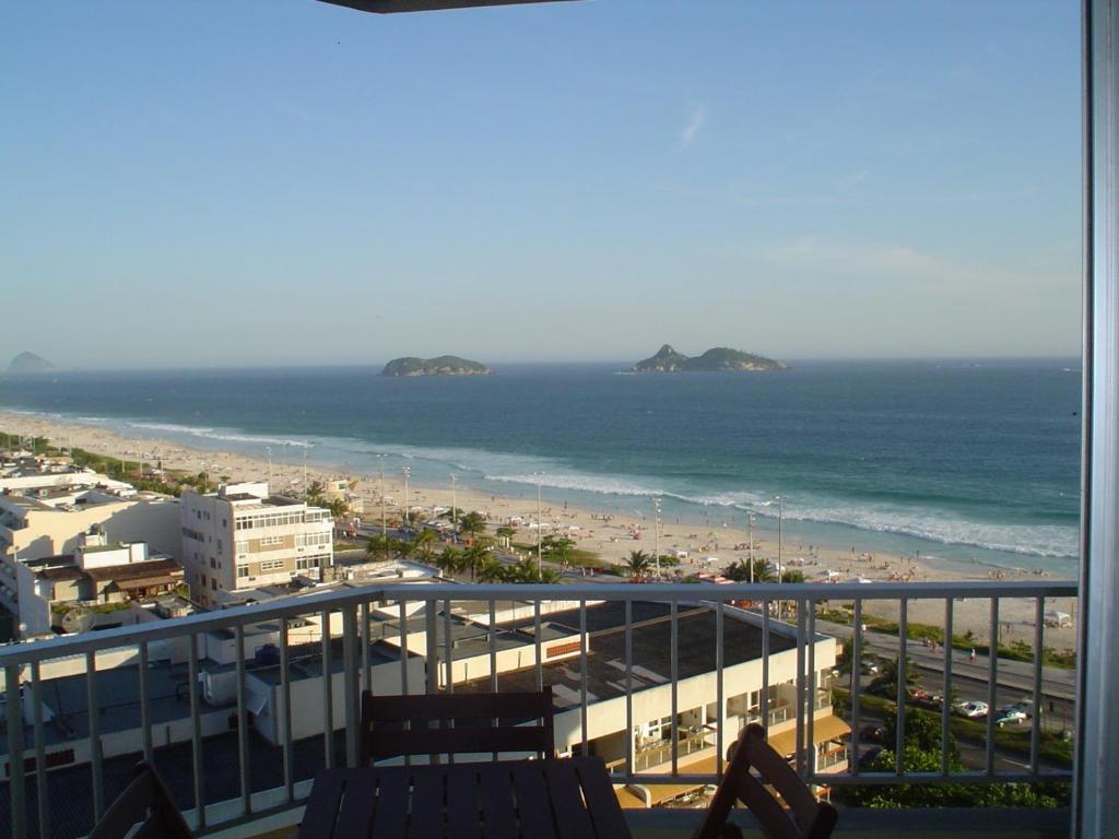 a view of the beach and the ocean from a balcony at Barra Palace in Rio de Janeiro