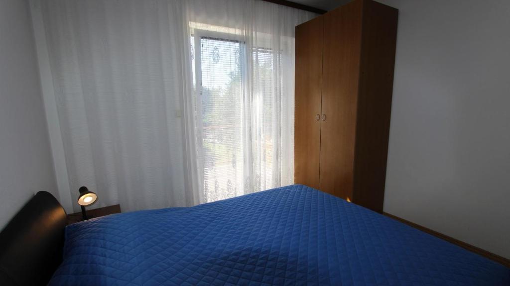 Postel nebo postele na pokoji v ubytování Apartments Gržetić
