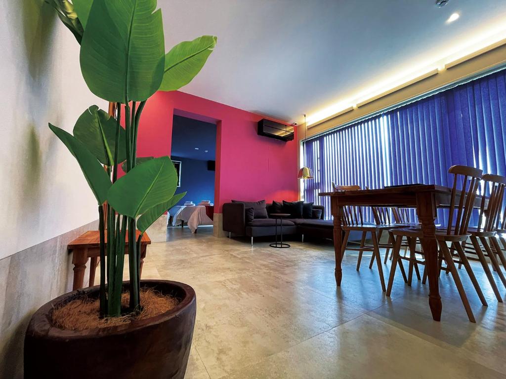 a living room with a table and a potted plant at CHULAX OKINAWA YOMITAN【Designer Condominium Hotel】 in Yomitan