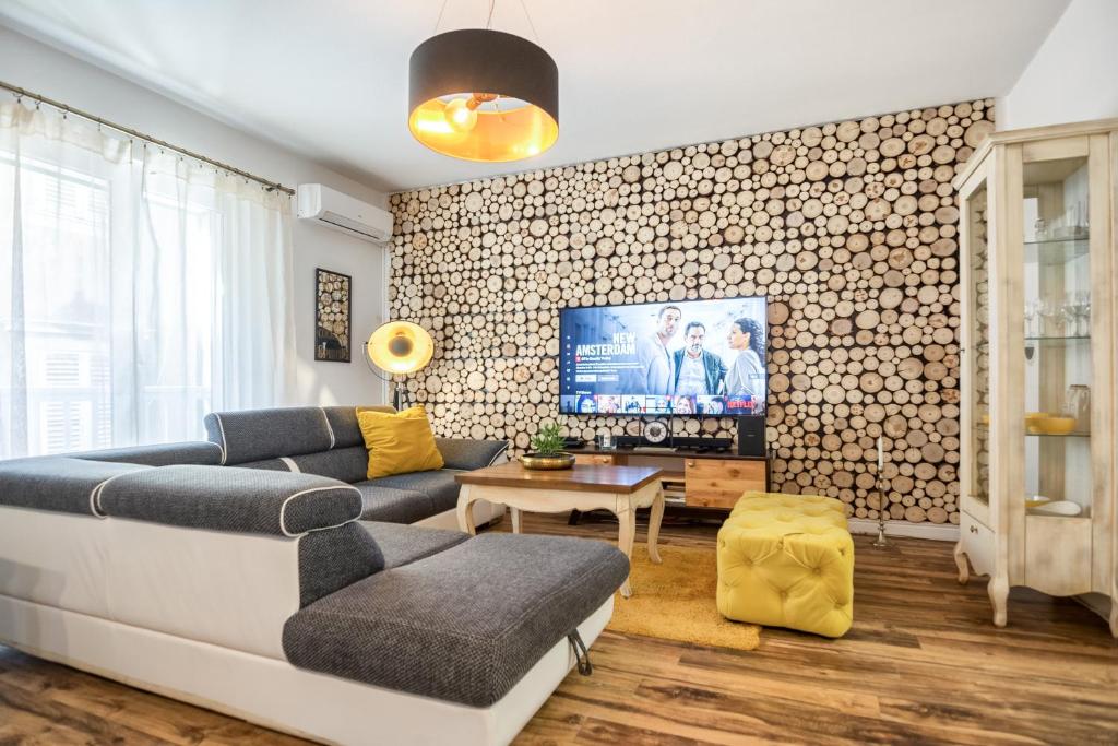 a living room with a couch and a tv at Francesca Luxury Apartment in Zadar