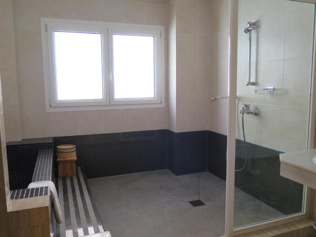 a bathroom with a shower and a sink and a window at La Luna Blanca in Torremolinos