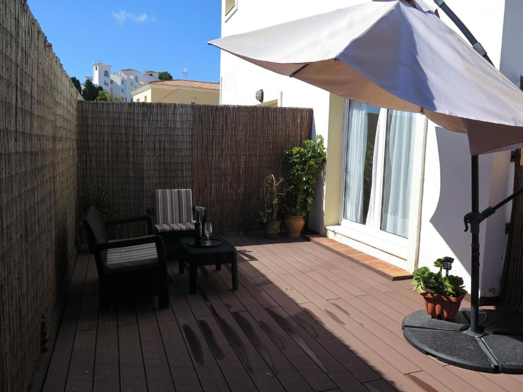 a patio with a table and an umbrella at La Luna Blanca in Torremolinos