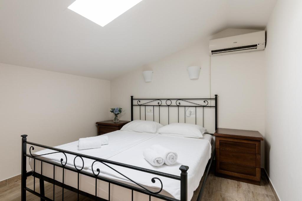a bedroom with a bed with two towels on it at Miracolo di Mare Retro in Piran