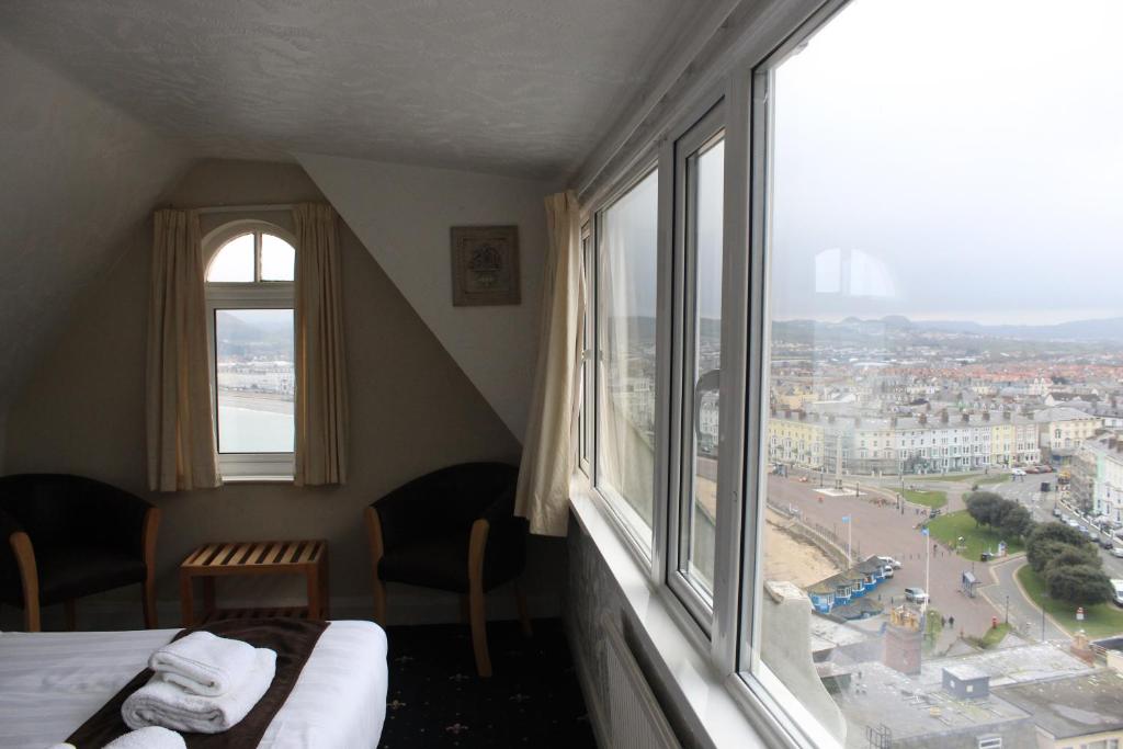 a hotel room with a view of a city from a window at Headlands Hotel in Llandudno