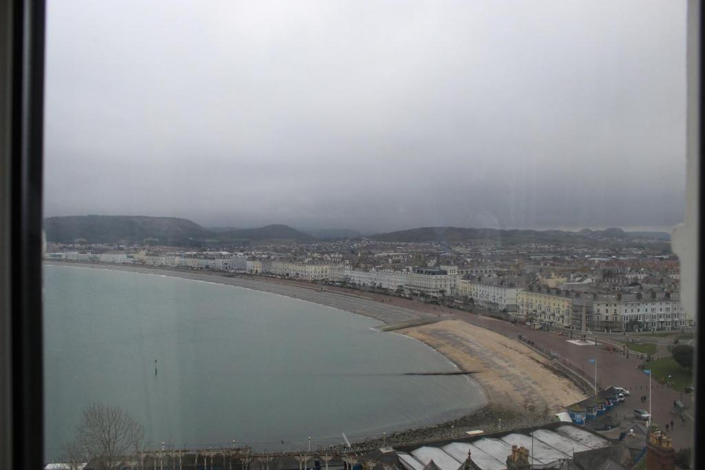 a view of a beach with buildings and a city at Headlands Hotel in Llandudno