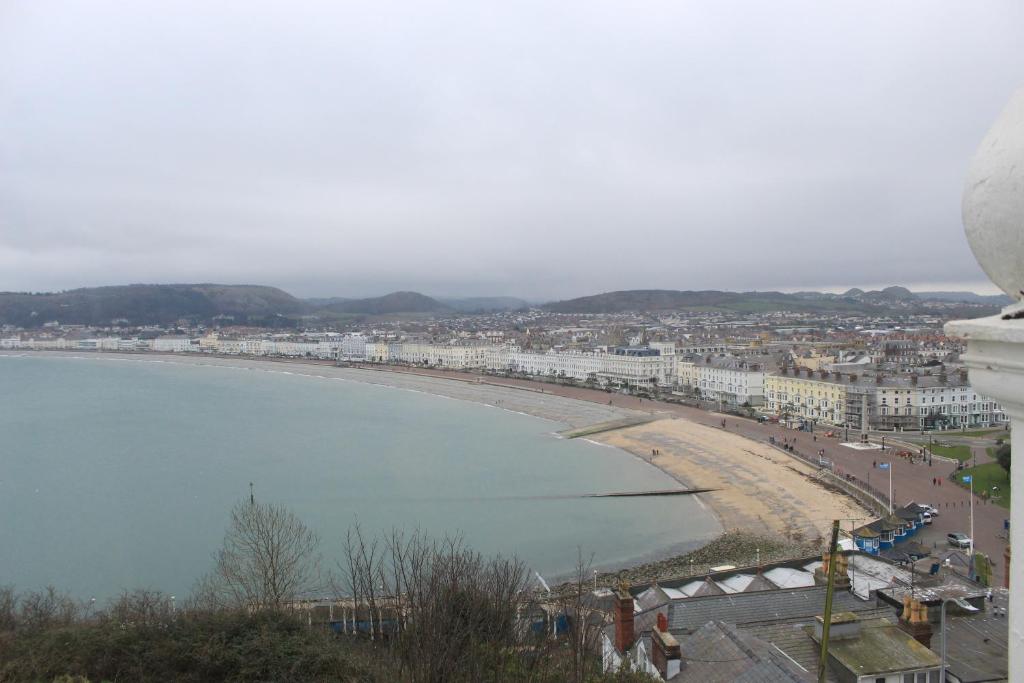 a view of a beach with buildings and a city at Headlands Hotel in Llandudno