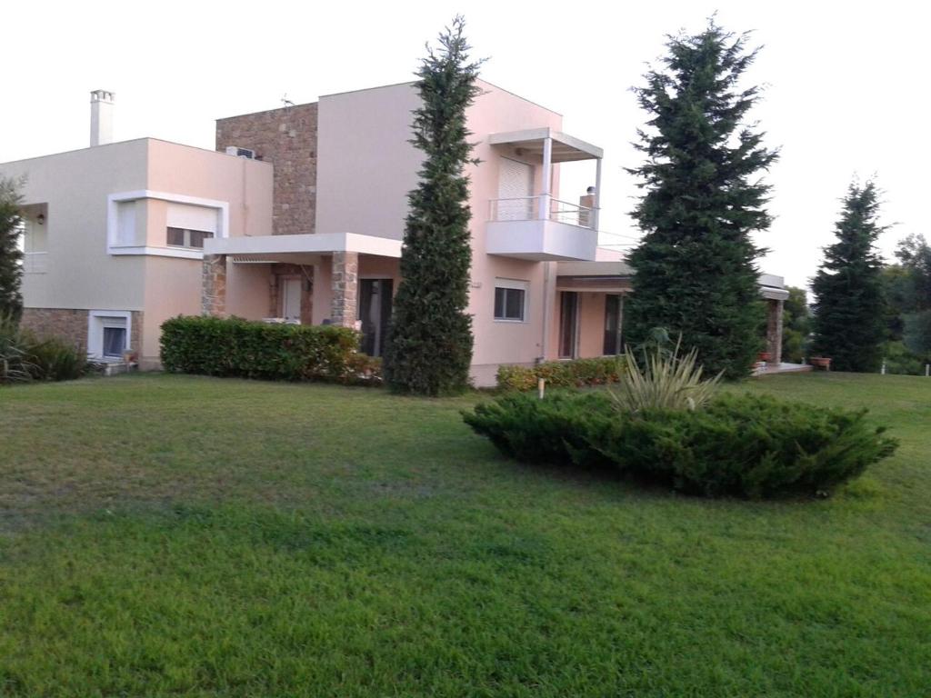 a large house with a yard in front of it at Villa Achilleos in Possidi