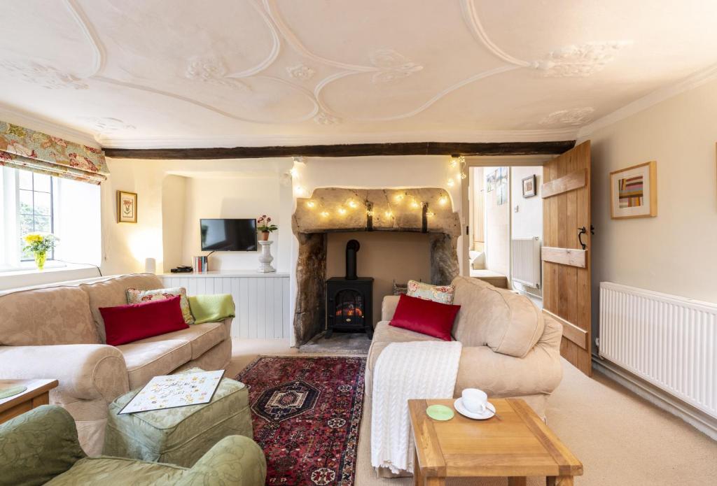 a living room with two couches and a fireplace at The Elbow in Dorchester