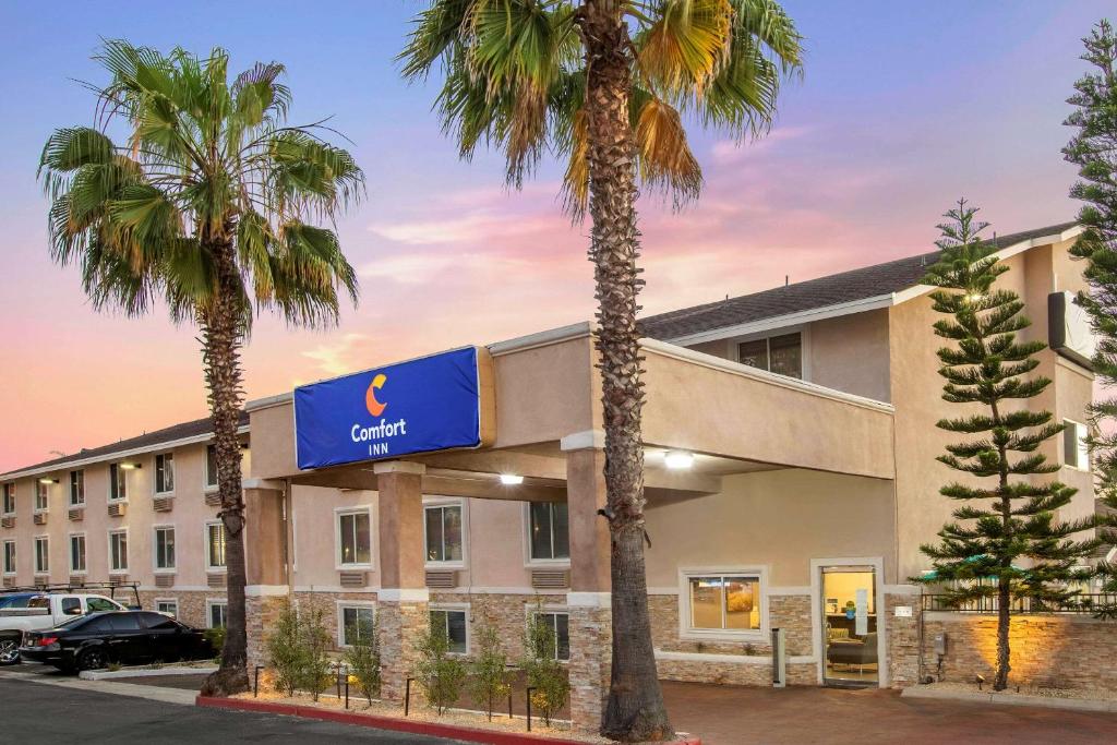 a hotel with palm trees in front of it at Comfort Inn San Diego Miramar in Miramar