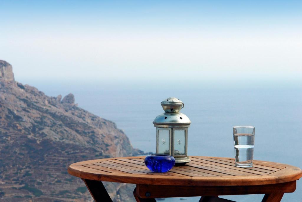 a lantern sitting on a table with a glass at Anatoli in Áno Meriá