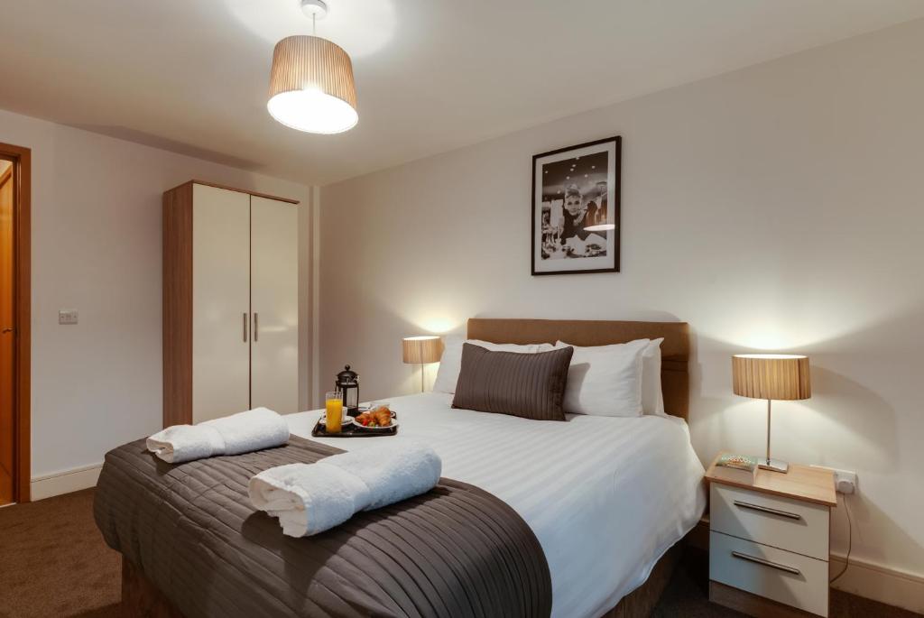 a bedroom with a large bed with two pillows at BOOK A BASE Apartments - Cumberland Street in Liverpool