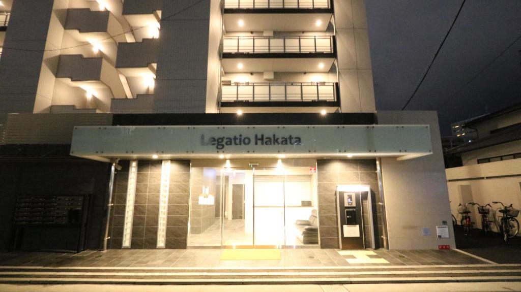 a building with a sign that reads echo hacienda habitat at Legatio Hakata Hotel in Fukuoka