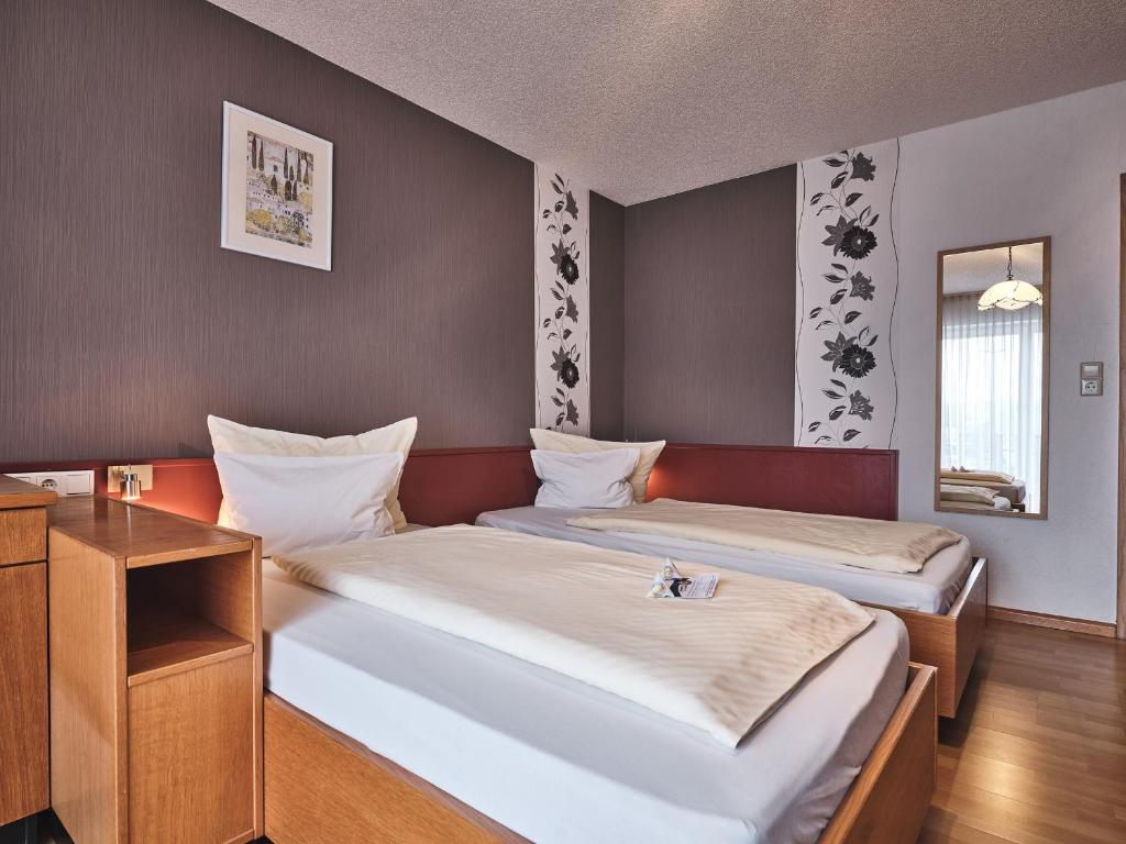Postel nebo postele na pokoji v ubytování TIPTOP Hotel am Hochrhein
