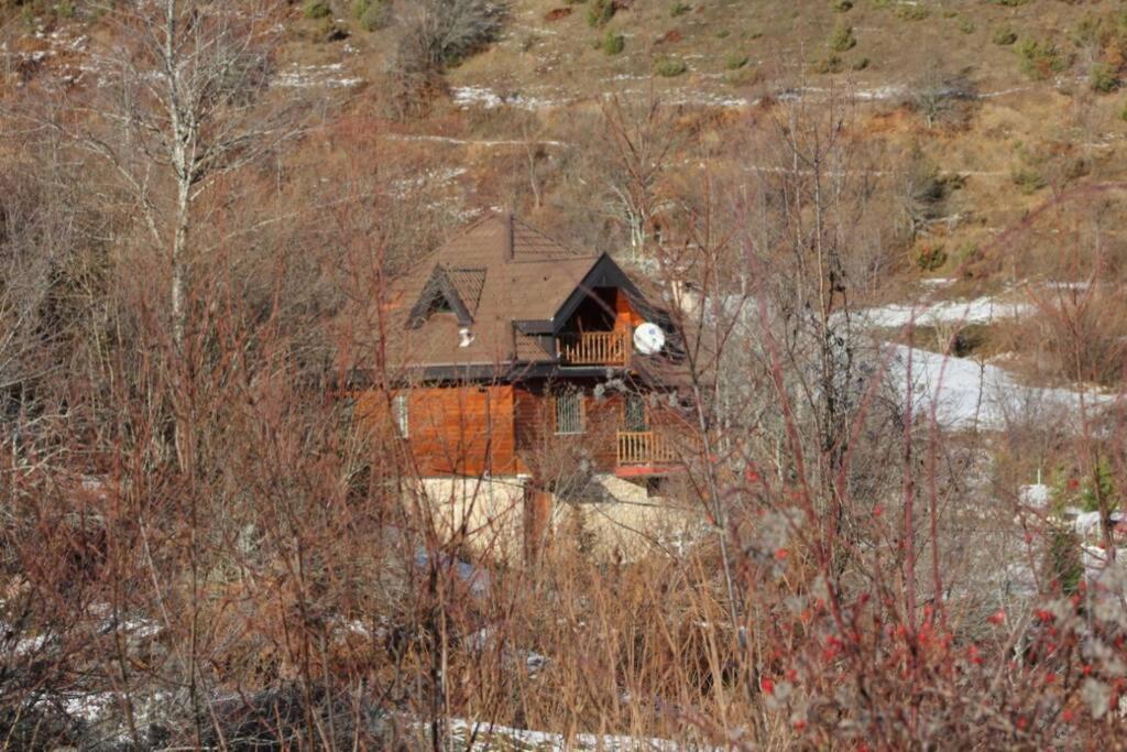 a house on a hill with snow on the ground at Albanian traditional Villa in Librazhd