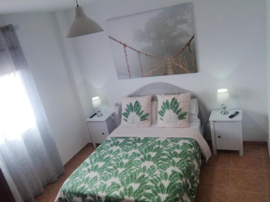 a bedroom with a bed and two night stands at CASA CANDELARIA,PARKING,AIR,WIFi in Candelaria