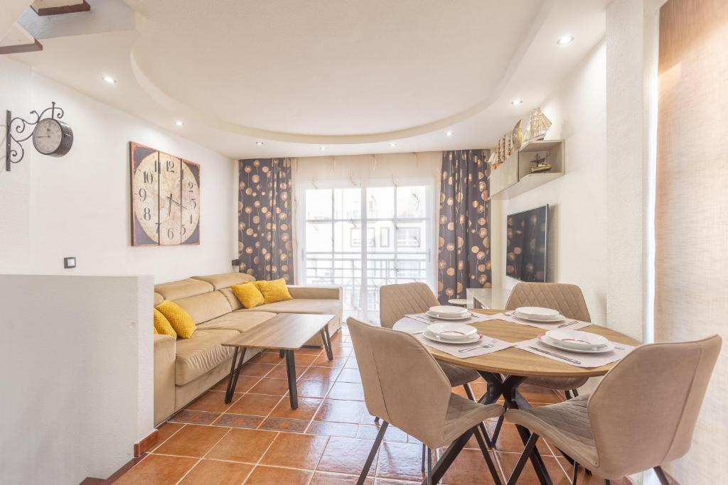 a living room with a table and a couch at Aqua Vista 2 bed Penthouse with great views in Callao Salvaje