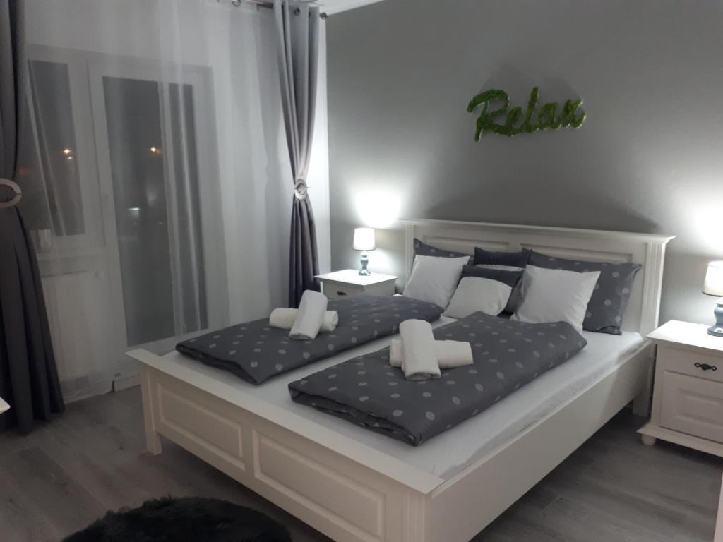 a bedroom with a bed with two pillows on it at Angel Residence in Sibiu